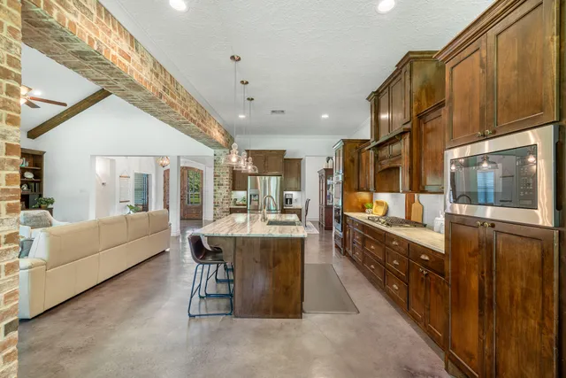 a large white kitchen with a large window and counter