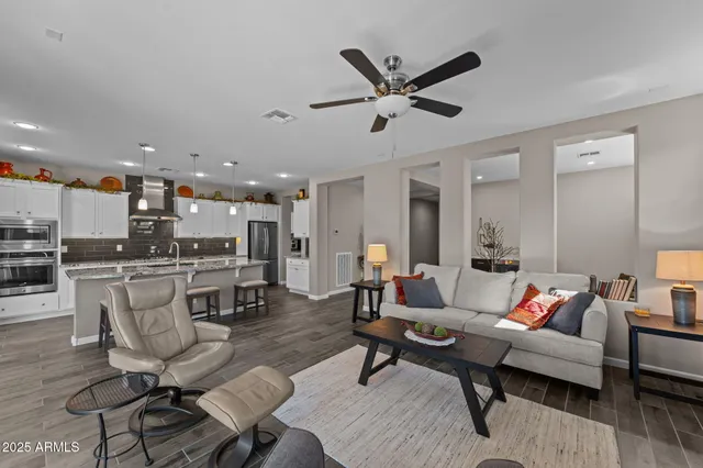 a living room with furniture and kitchen view