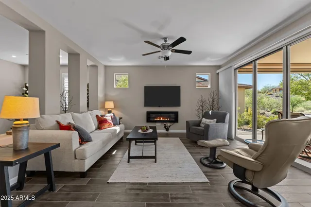 a living room with furniture a rug and a flat screen tv