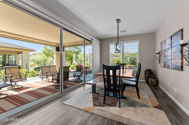 a kitchen with granite countertop white cabinets and stainless steel appliances