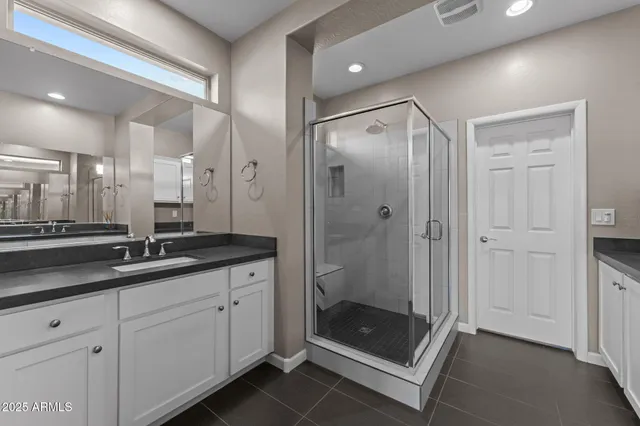 a bathroom with a shower and a sink