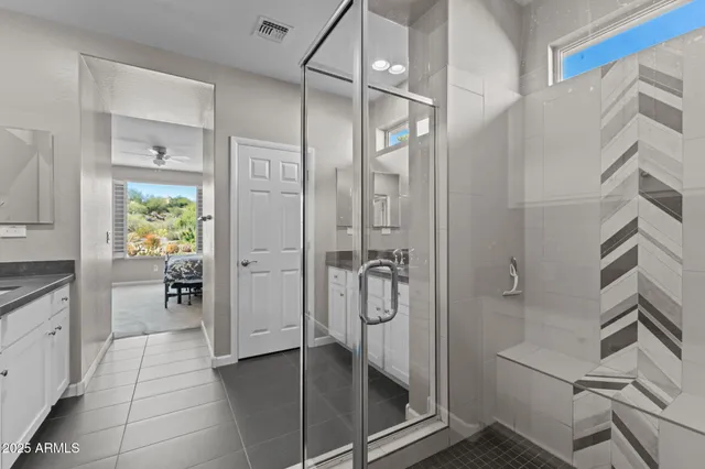 a living room with furniture and floor to ceiling windows