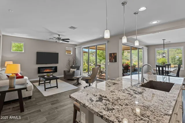 a living room with furniture a flat screen tv and a large window