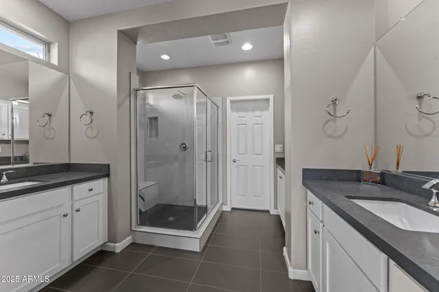 a spacious bathroom with a granite countertop sink mirror and shower