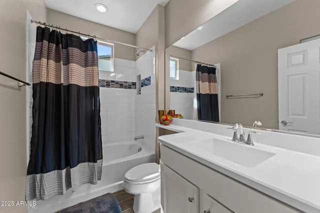 a bathroom with a sink a toilet a shower and a mirror