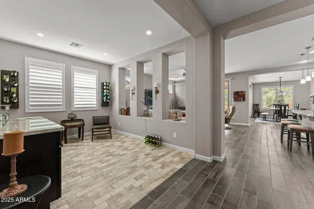 a living room with furniture a window and wooden floor