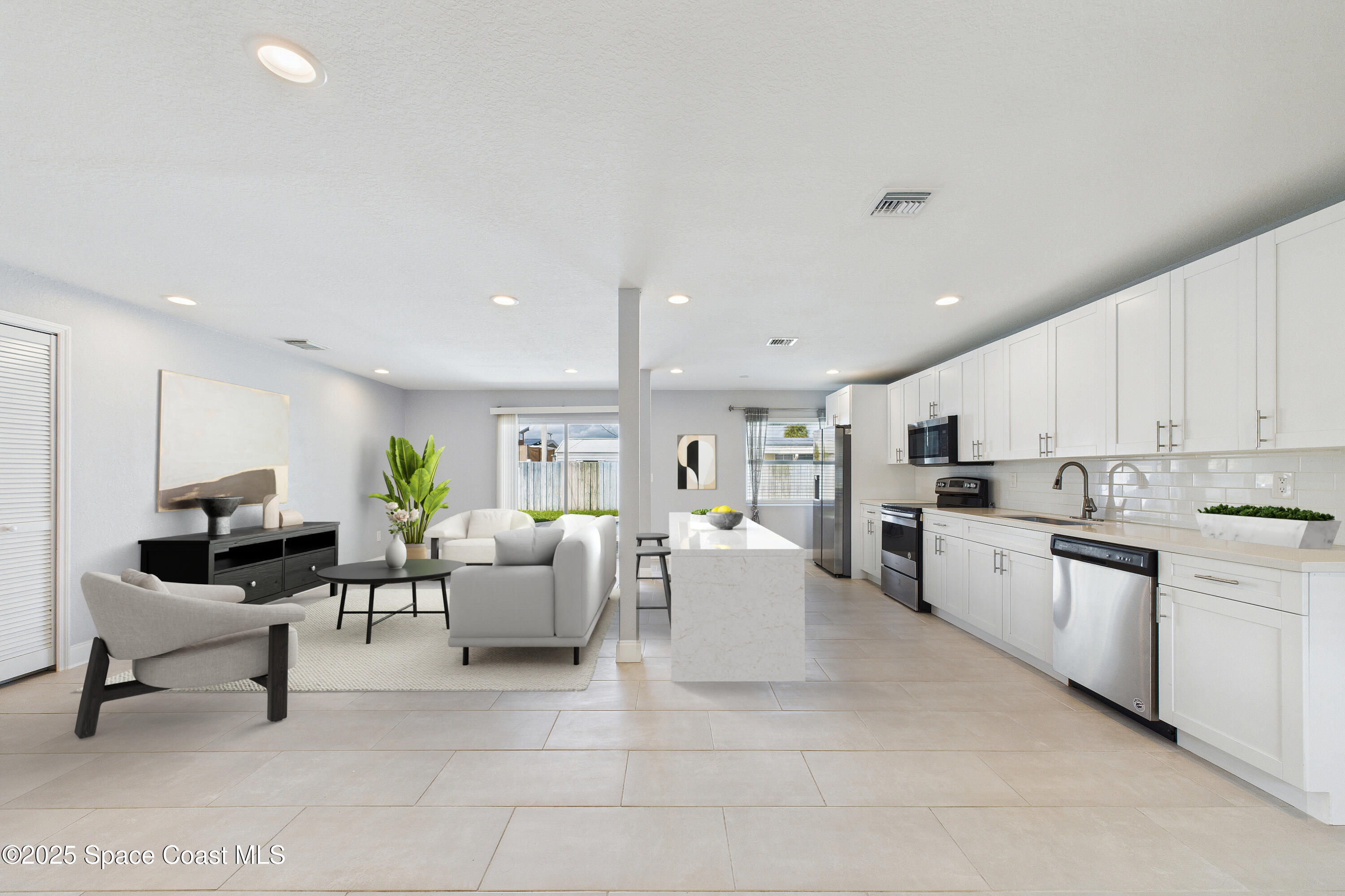 1500 Dorsal Street Merritt Island, FL 32952 - Photo 12 of 56 a living room with stainless steel appliances furniture a rug and a kitchen view