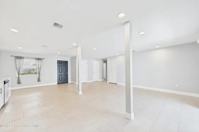 a view of a kitchen with a sink and a refrigerator