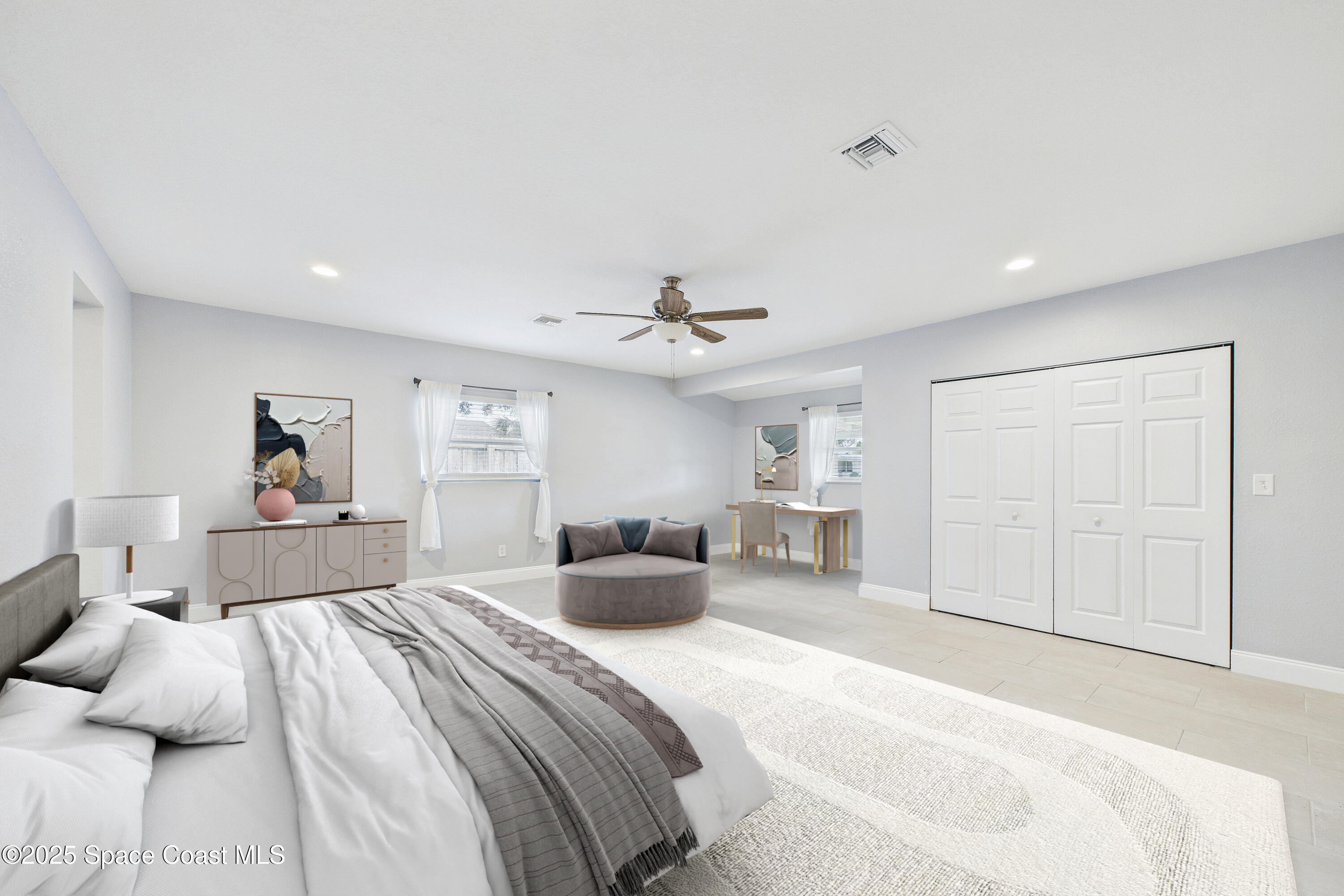 1500 Dorsal Street Merritt Island, FL 32952 - Photo 28 of 56 a bedroom with a large bed and a chandelier