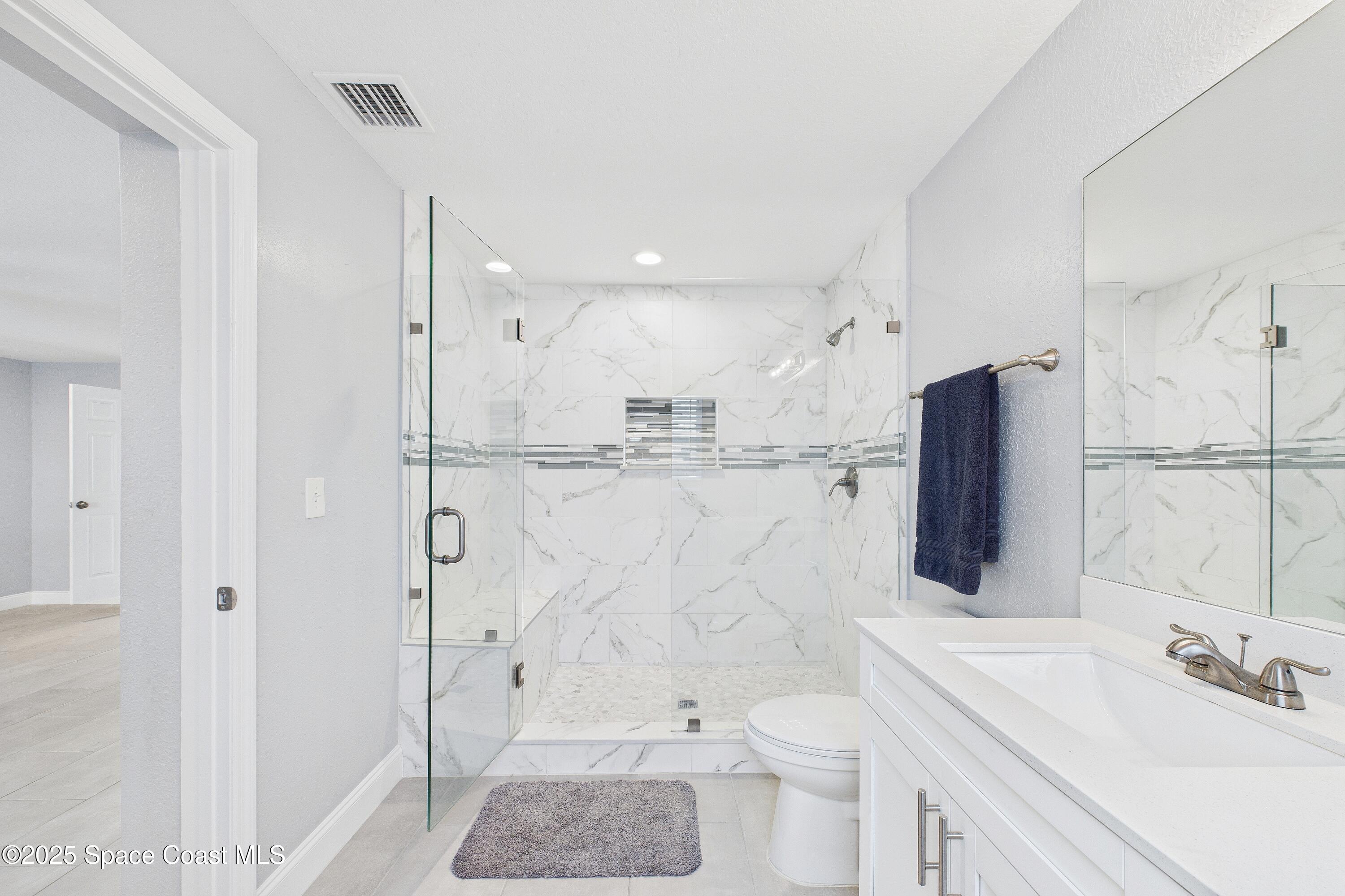 1500 Dorsal Street Merritt Island, FL 32952 - Photo 30 of 56 a bathroom with a sink a toilet and shower