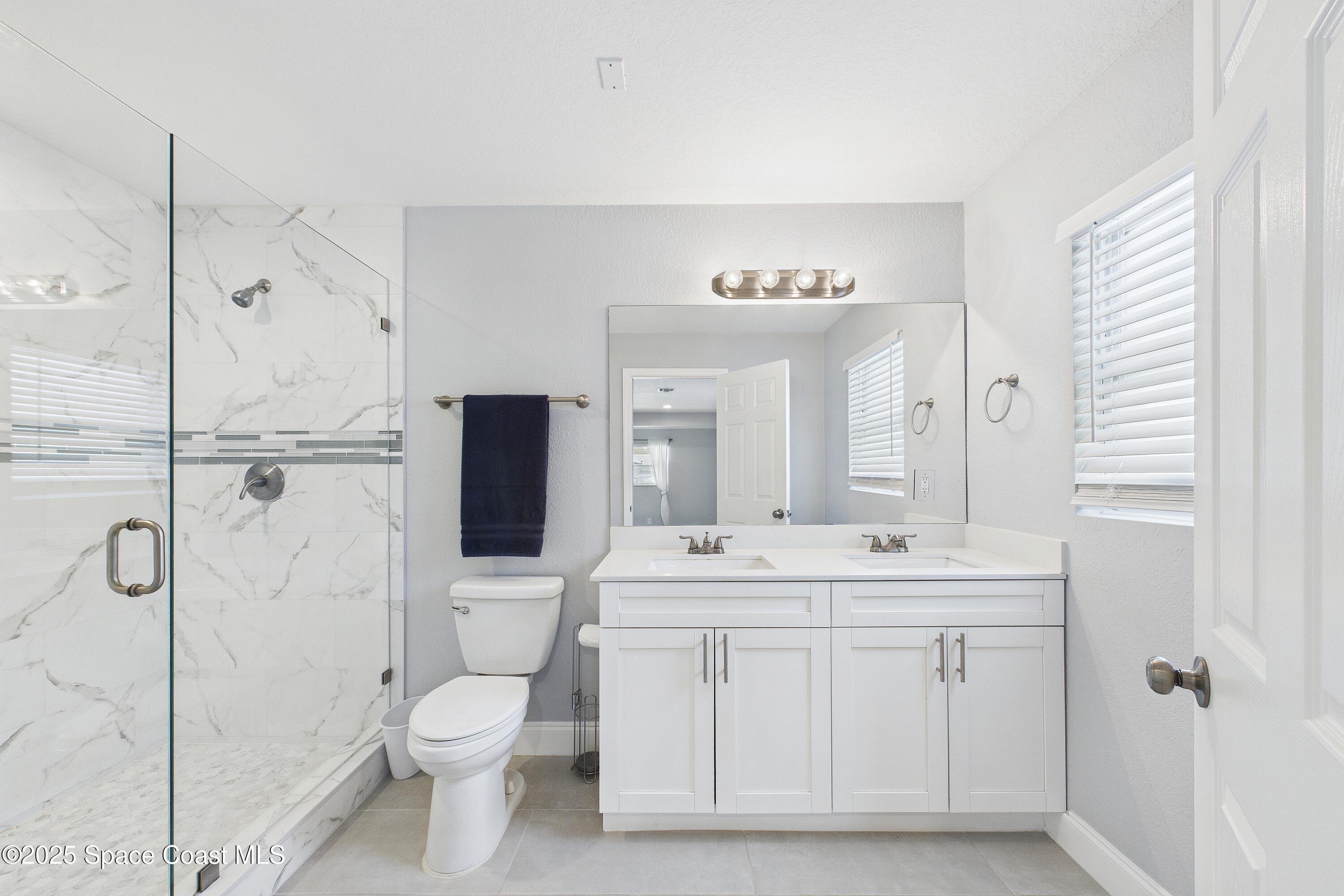1500 Dorsal Street Merritt Island, FL 32952 - Photo 31 of 56 a spacious bathroom with a granite countertop sink toilet and shower