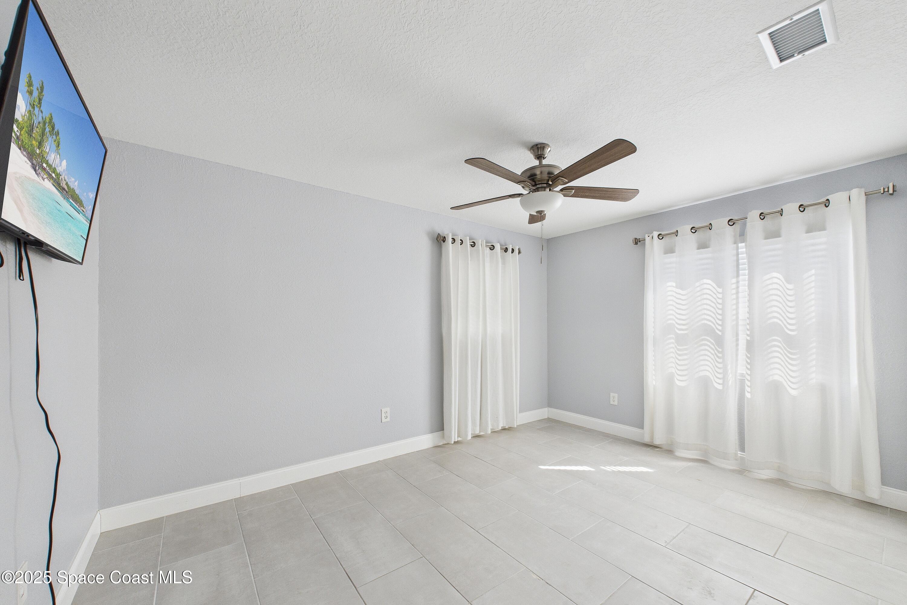 1500 Dorsal Street Merritt Island, FL 32952 - Photo 32 of 56 a view of a livingroom with a ceiling fan & a window