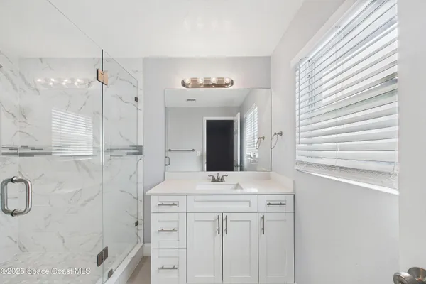 an empty room with a fan and a ceiling fan