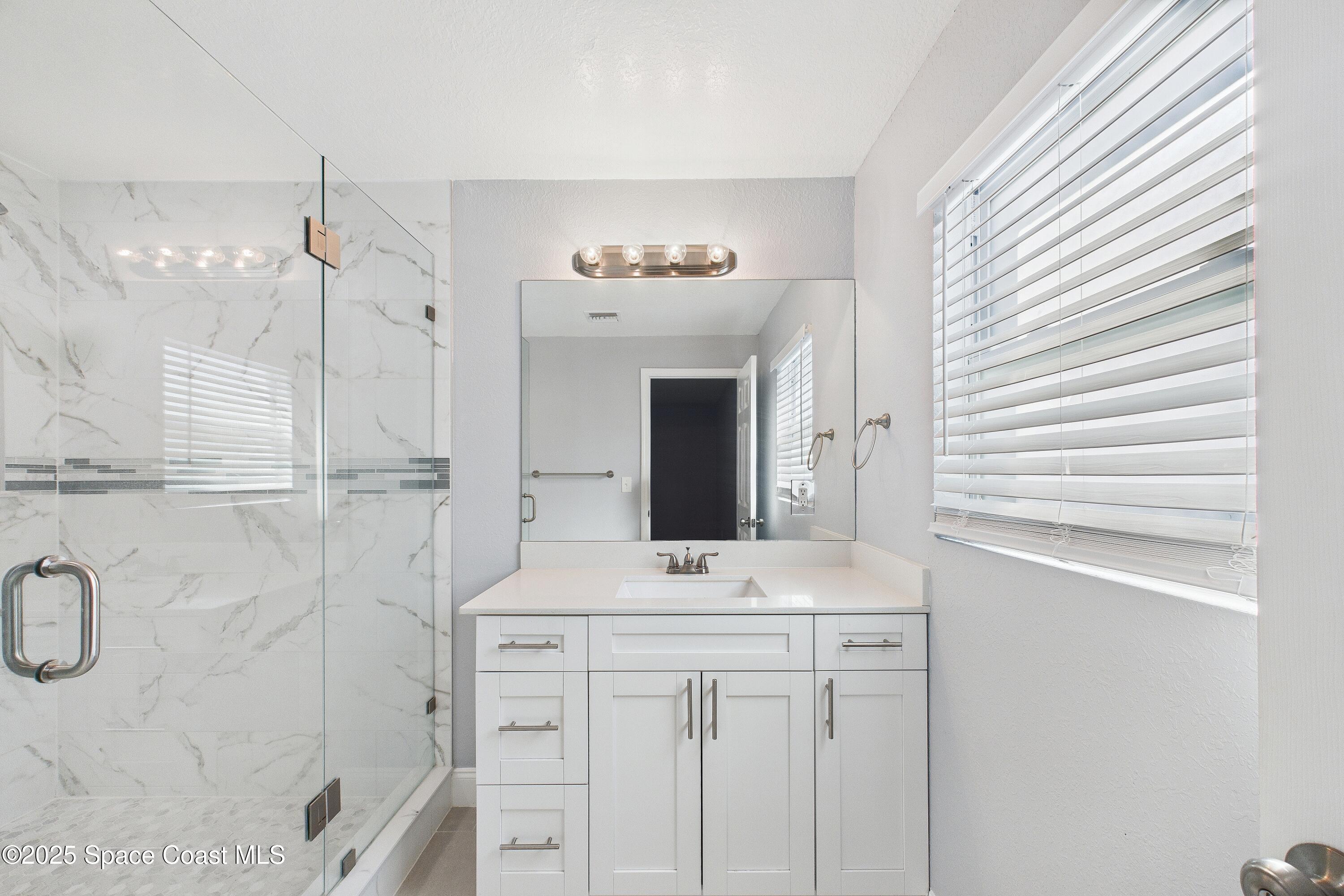 1500 Dorsal Street Merritt Island, FL 32952 - Photo 36 of 56 a bathroom with a sink vanity and shower