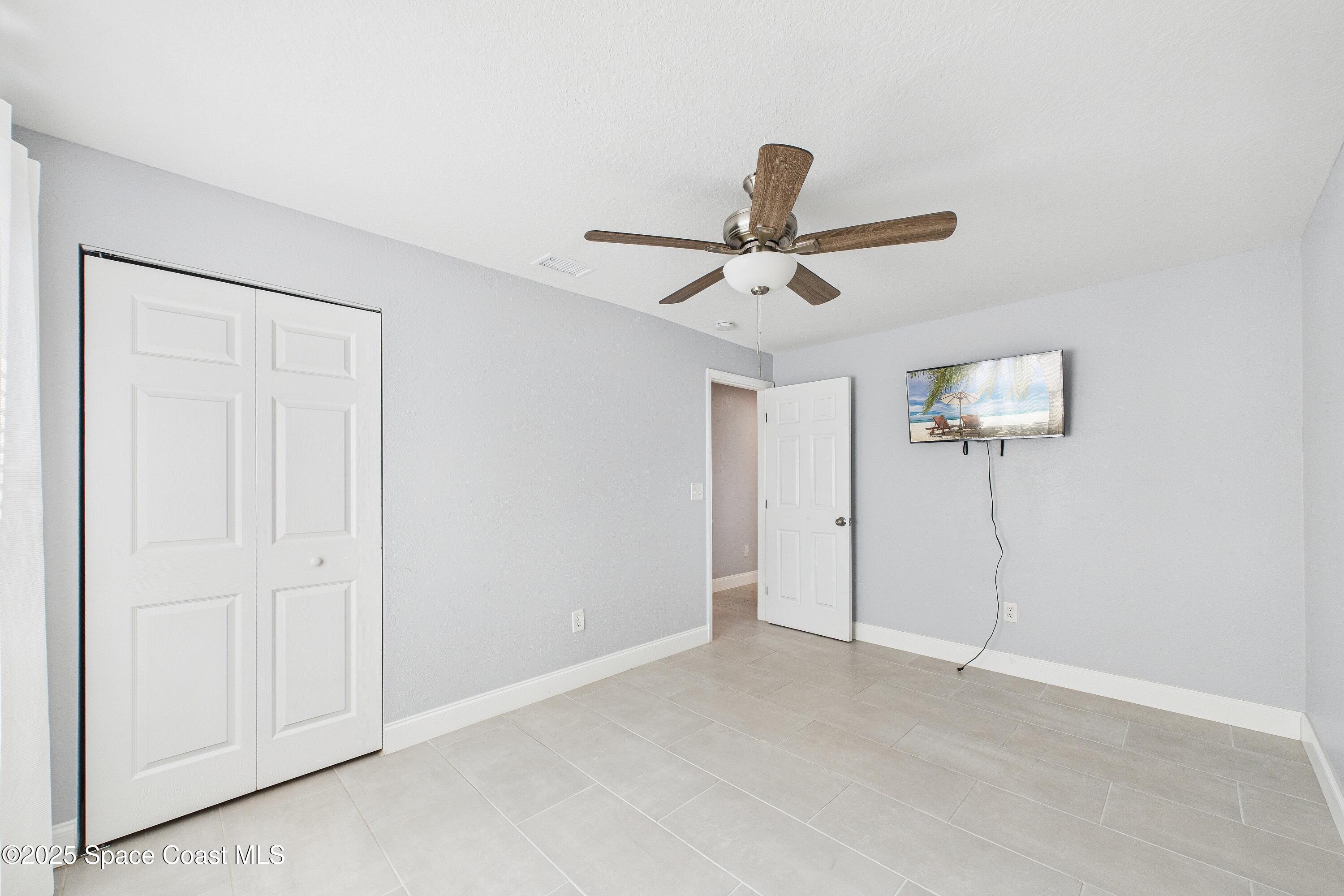1500 Dorsal Street Merritt Island, FL 32952 - Photo 38 of 56 an empty room with a fan and a ceiling fan