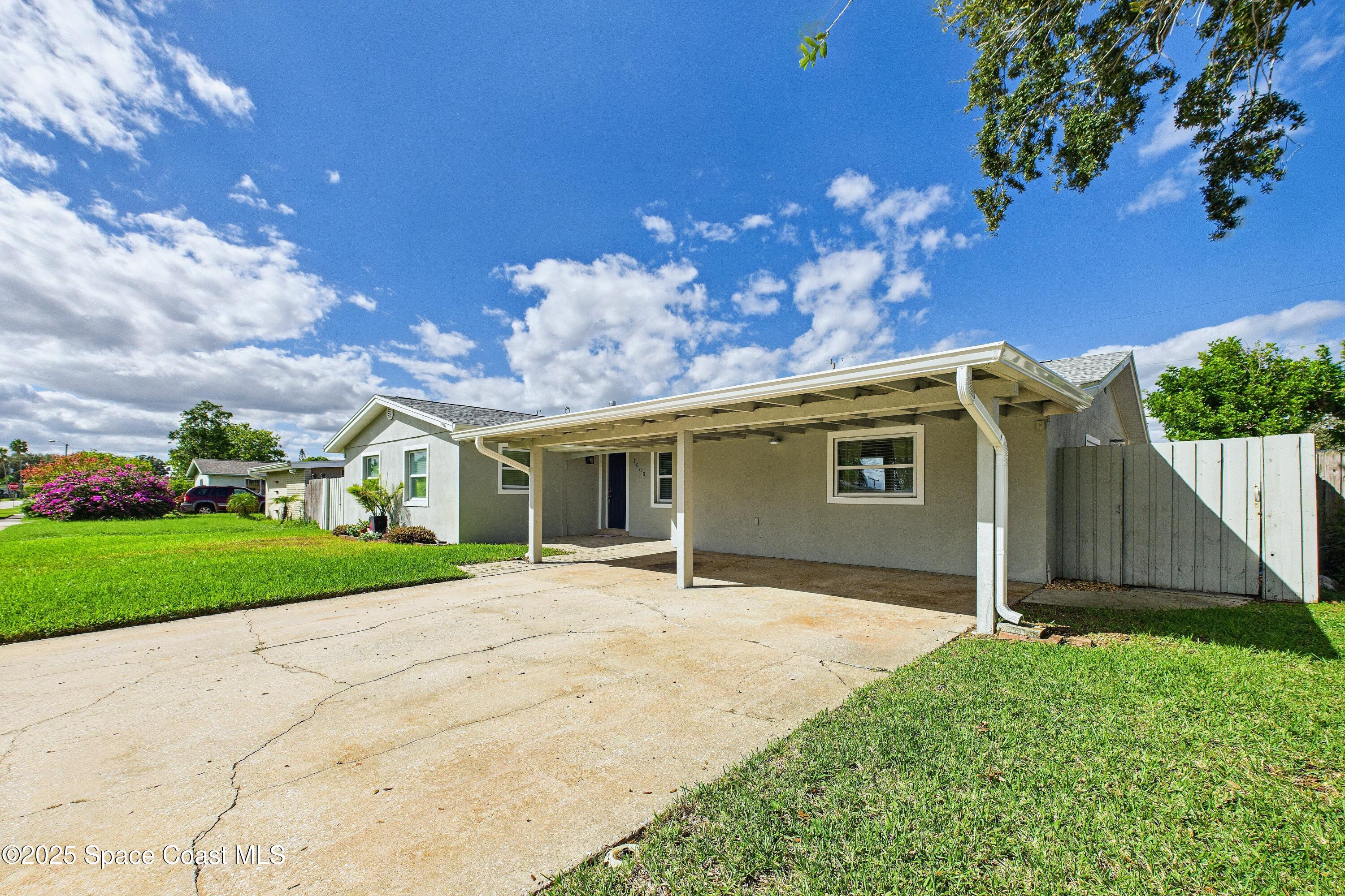 1500 Dorsal Street Merritt Island, FL 32952 - Photo 4 of 56 a front view of a house with garden
