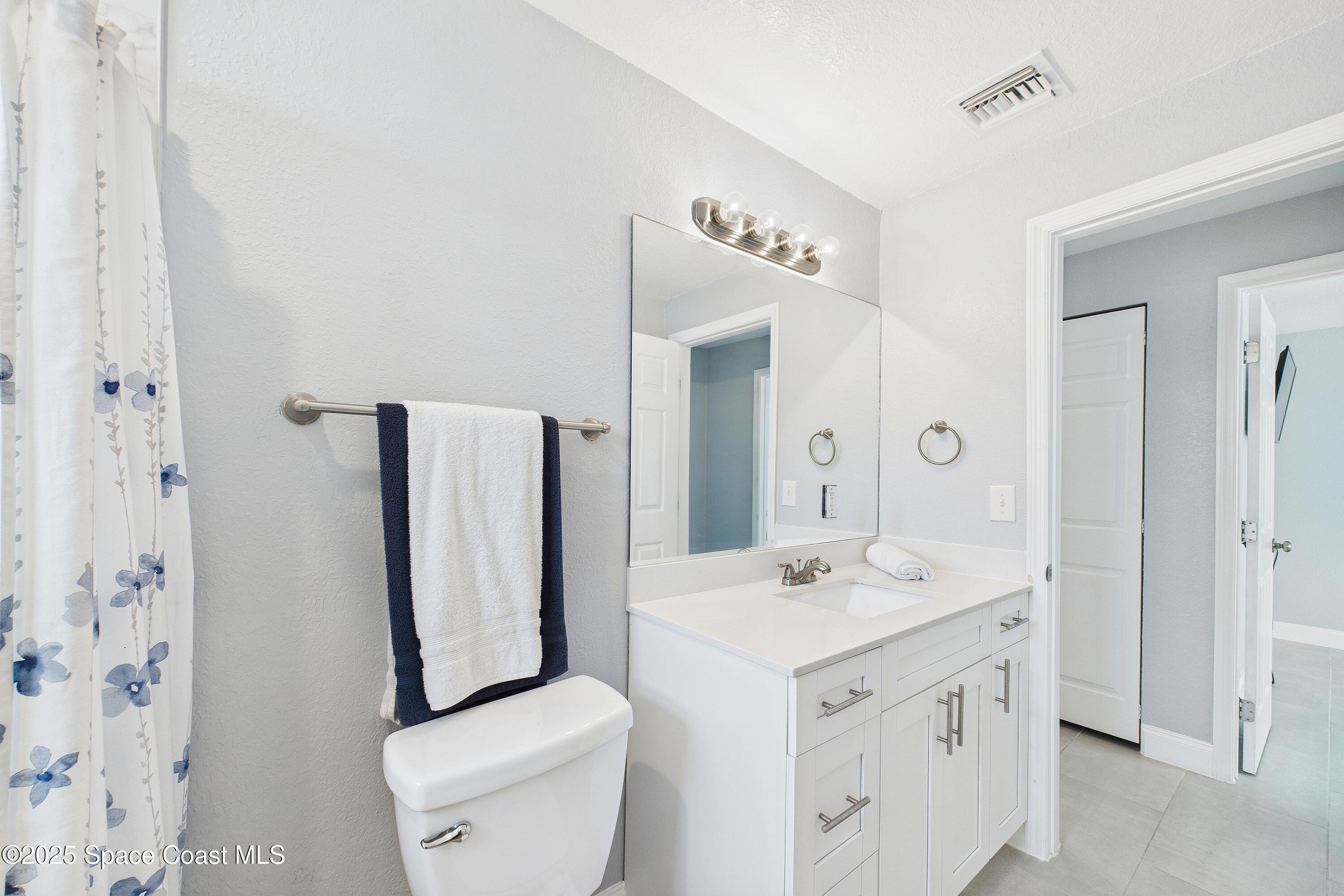 1500 Dorsal Street Merritt Island, FL 32952 - Photo 41 of 56 a bathroom with a sink a toilet and shower