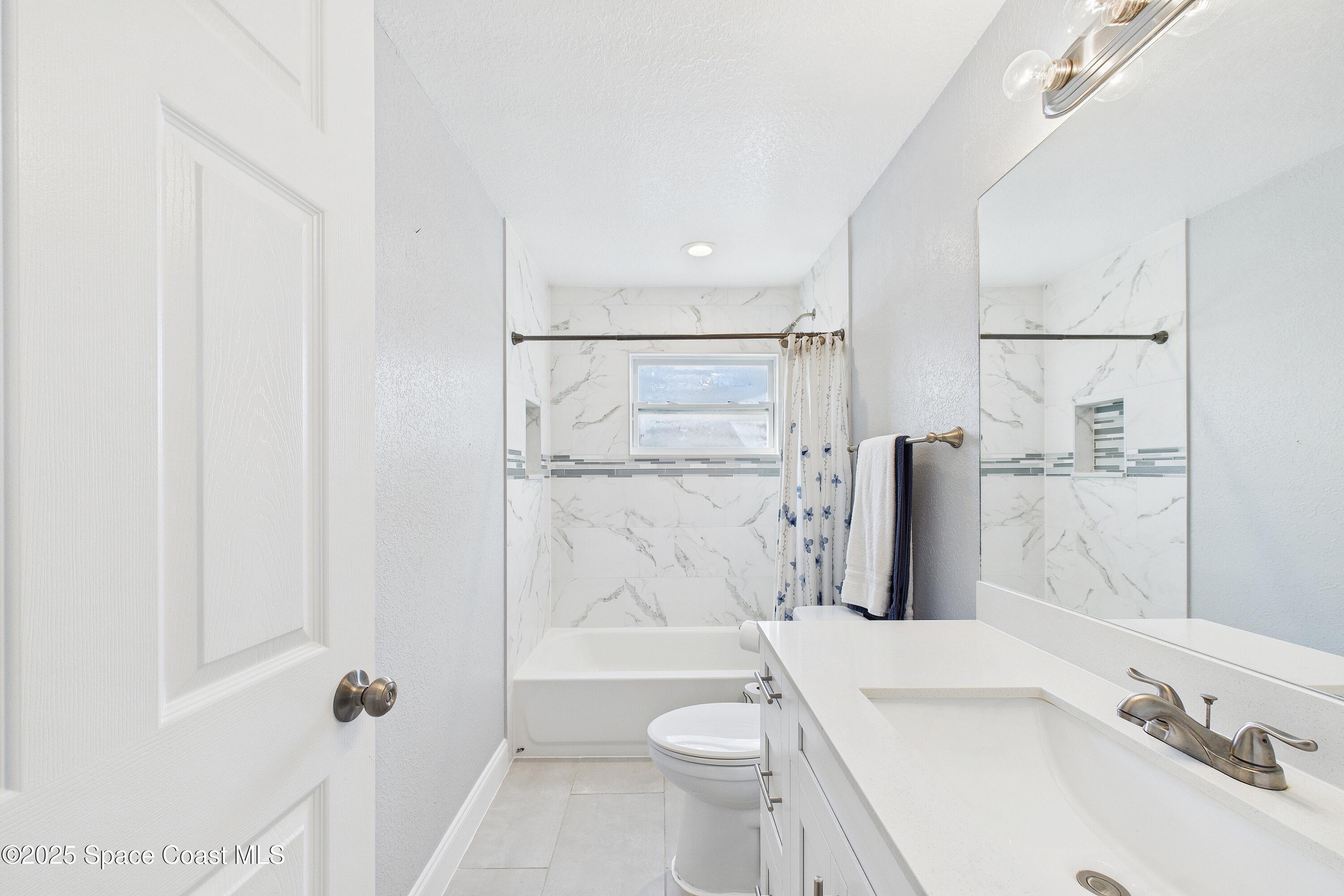 1500 Dorsal Street Merritt Island, FL 32952 - Photo 42 of 56 a bathroom with a sink a toilet and shower