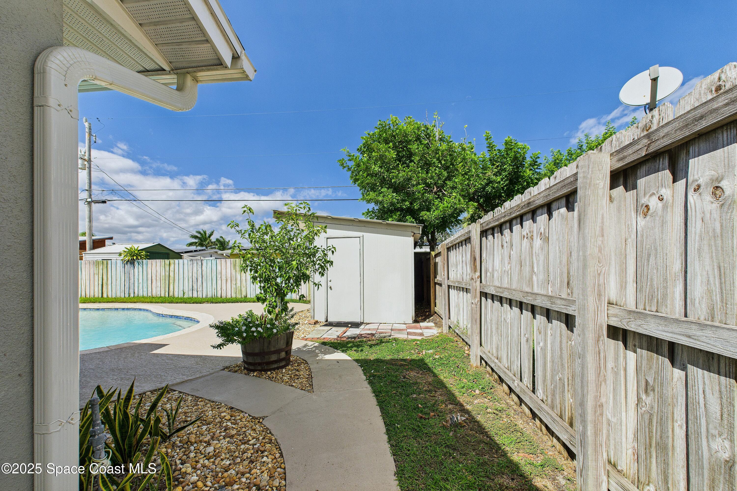 1500 Dorsal Street Merritt Island, FL 32952 - Photo 47 of 56 a view of a porch with a flower garden