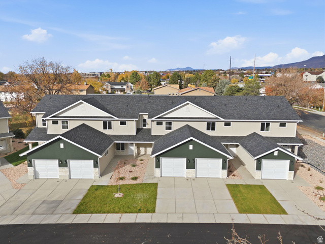 1615 North Angel Street, Unit E Layton, UT 84041 - Photo 35 of 42 Traditional-style home featuring stucco siding, driveway, a residential view, and a shingled roof