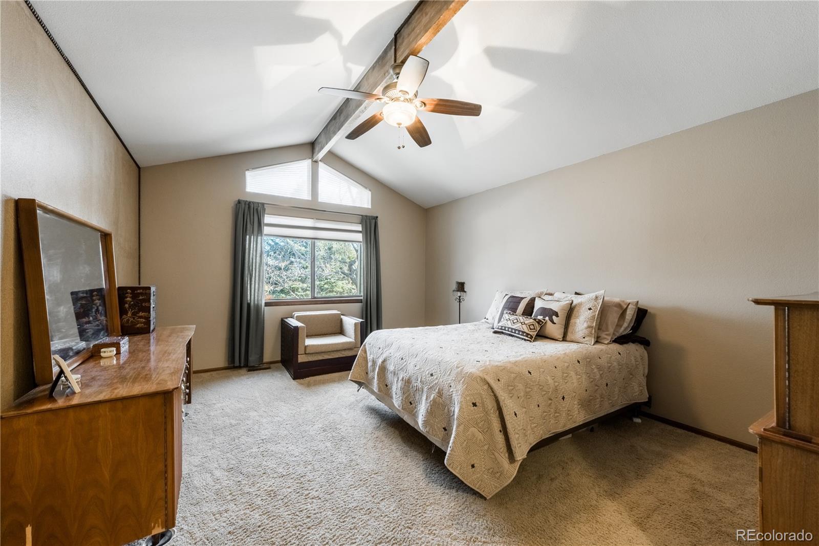 8583 Redstone Street Highlands Ranch, CO 80126 - Photo 13 of 25 a bedroom with a bed flat screen tv and window