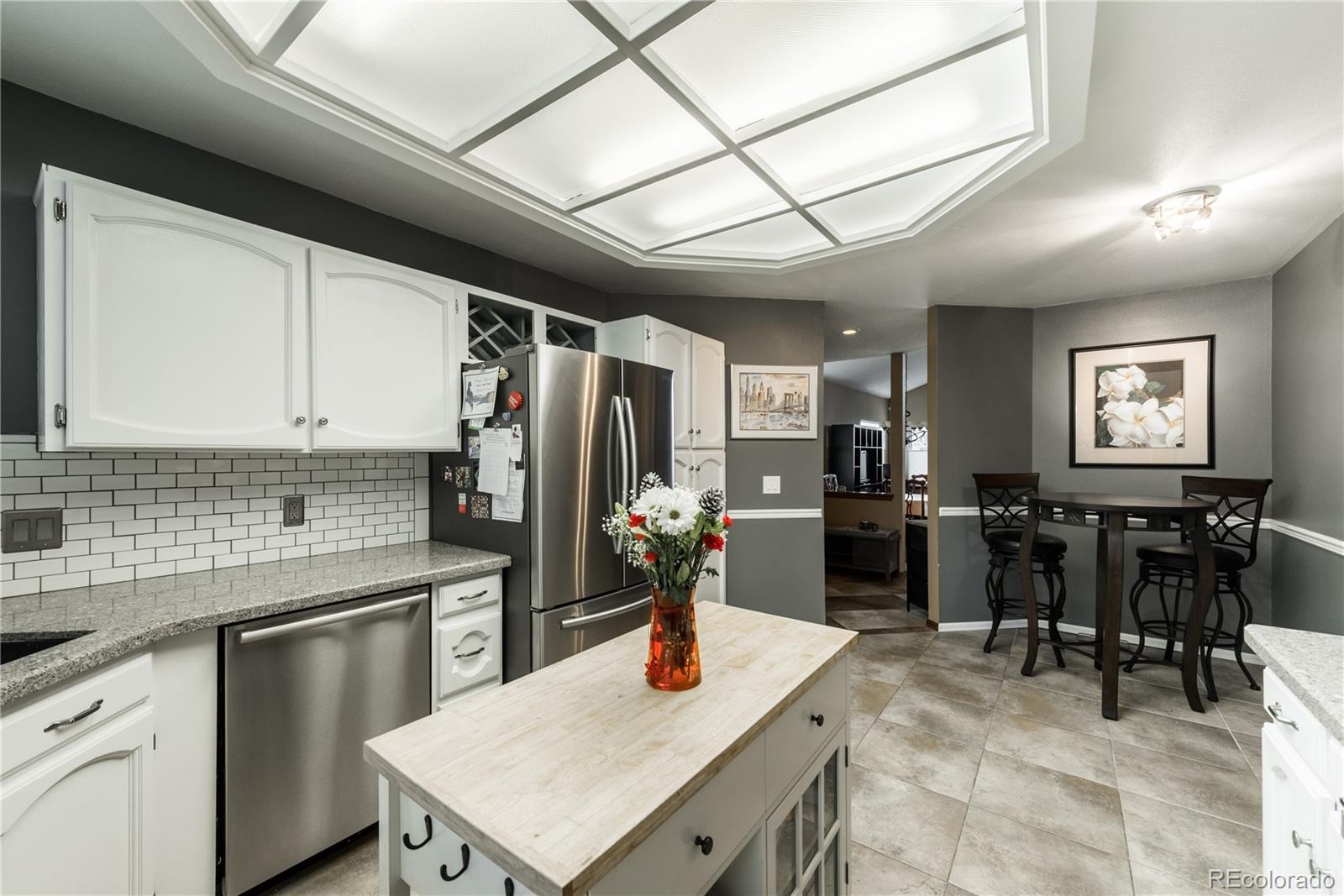 8583 Redstone Street Highlands Ranch, CO 80126 - Photo 2 of 25 a kitchen with stainless steel appliances granite countertop a sink a stove and refrigerator
