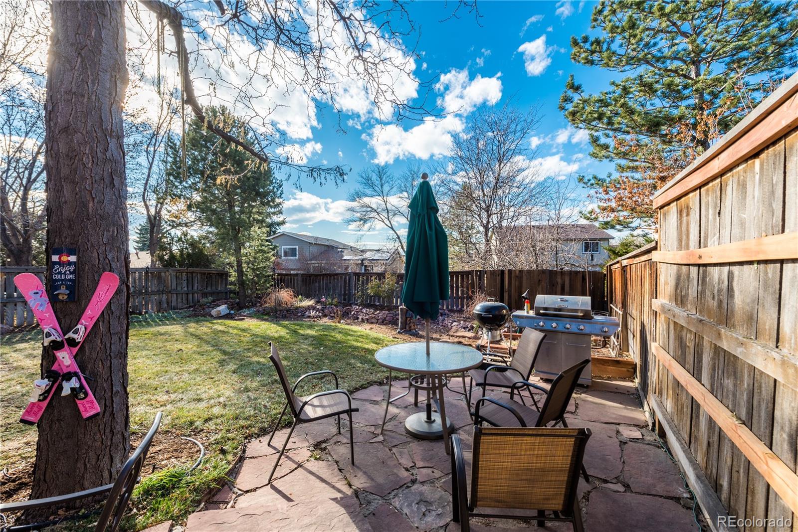 8583 Redstone Street Highlands Ranch, CO 80126 - Photo 25 of 25 a view of a chairs and table in backyard