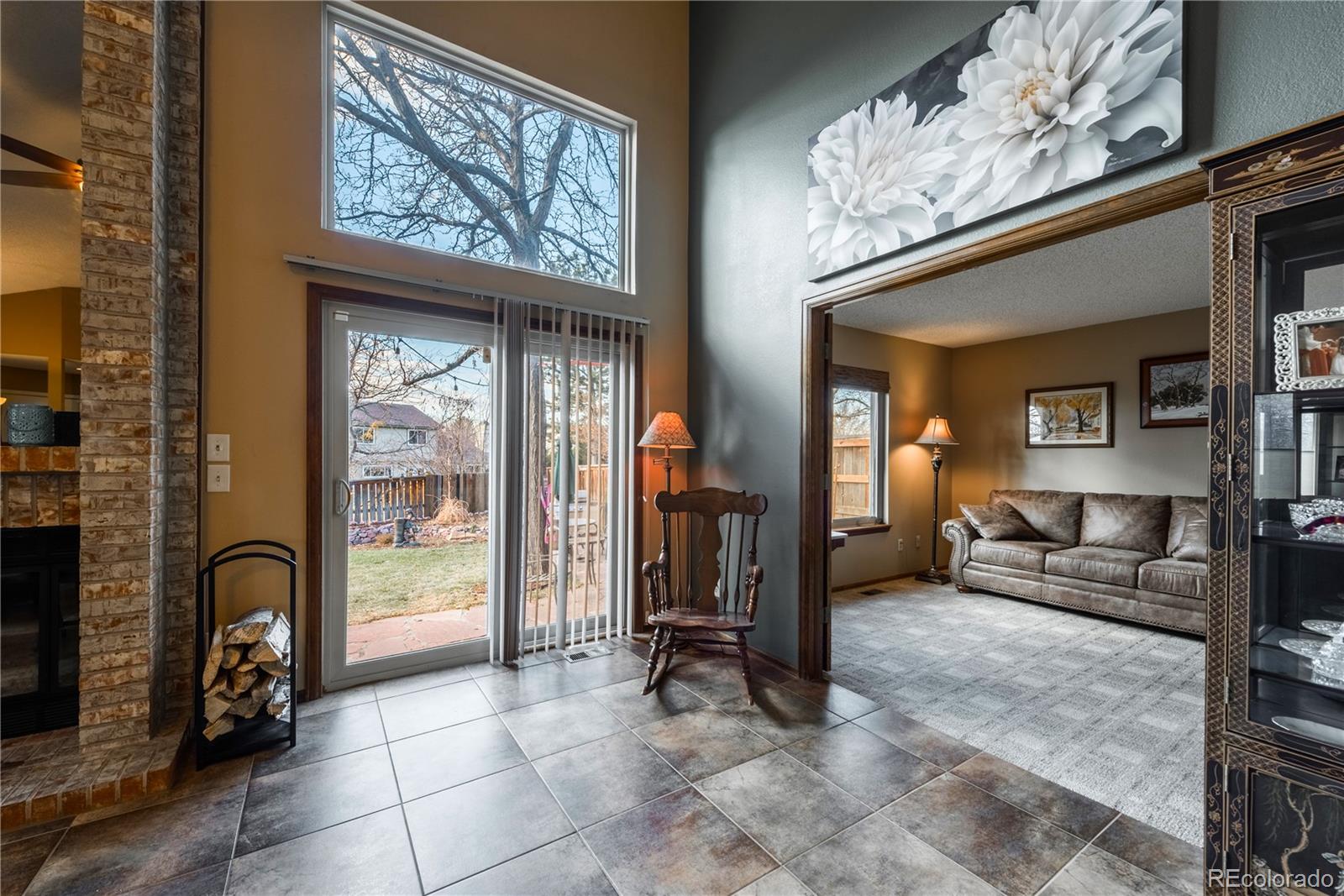 8583 Redstone Street Highlands Ranch, CO 80126 - Photo 6 of 25 a living room with furniture a couch and large windows