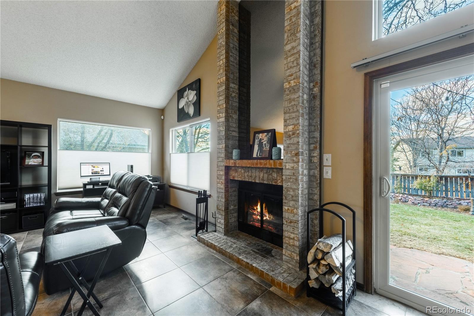 8583 Redstone Street Highlands Ranch, CO 80126 - Photo 7 of 25 a living room with furniture and a fireplace