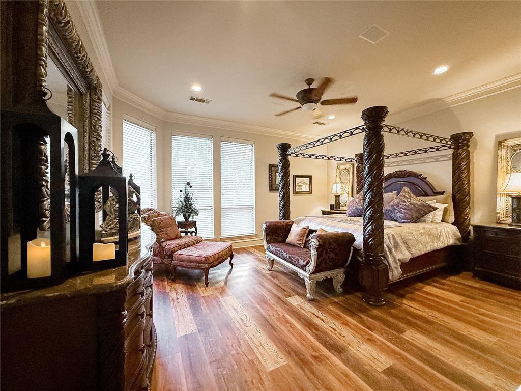 1919 Kings Pass Heath, TX 75032 - Photo 19 of 38 Bedroom with ornamental molding, wood finished floors, and ceiling fan