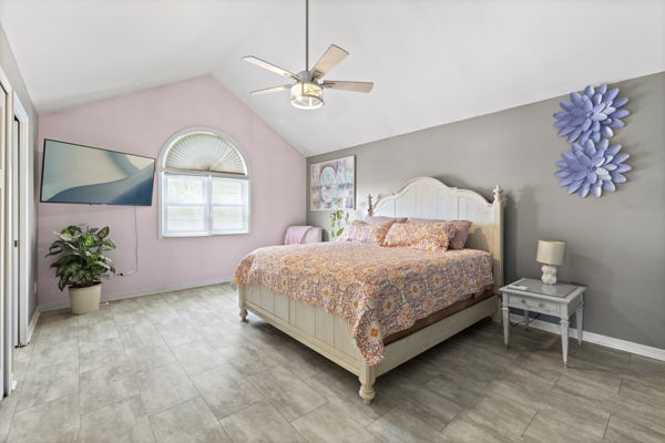 24222 Volbrecht Road Crete, IL 60417 - Photo 9 of 16 a spacious bedroom with a bed and a chandelier