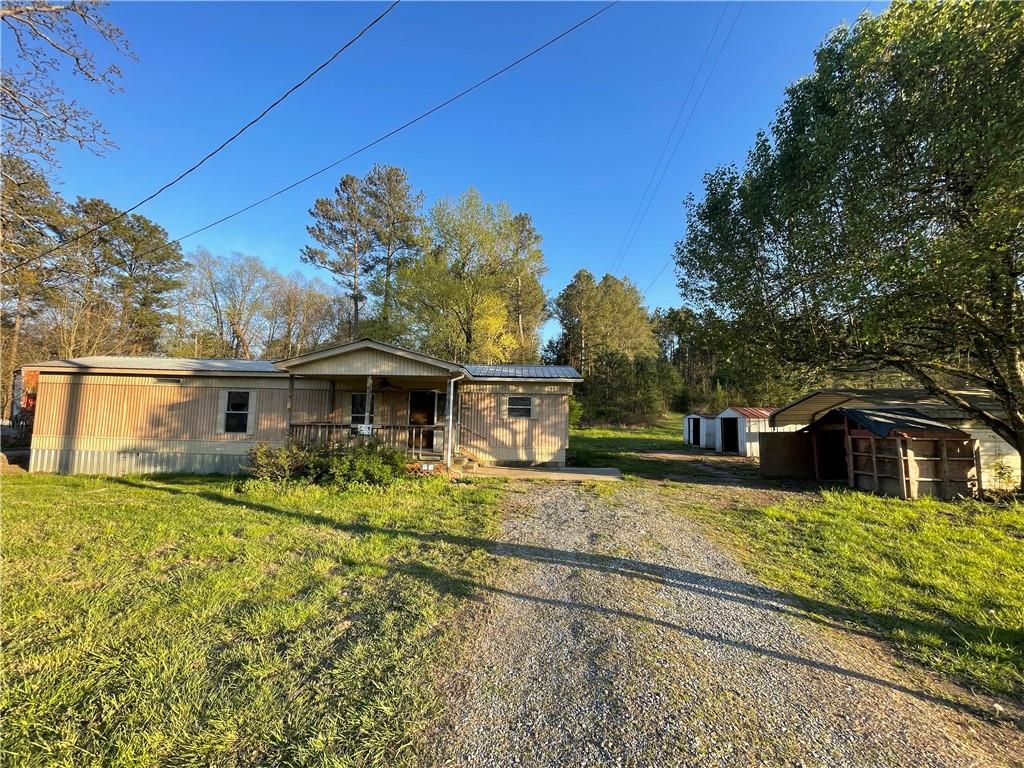 1097 School House Road Northeast Calhoun, GA 30701 - Photo 1 of 1 a view of a house with a big yard