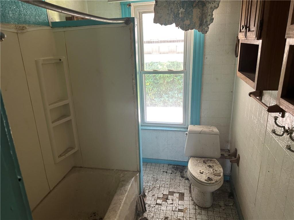 124 East 15th Avenue Homestead, PA 15120 - Photo 7 of 15 a bathroom with a toilet and a shower