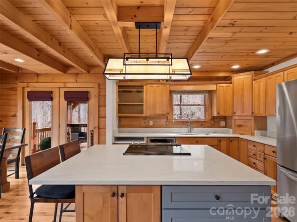 a kitchen with stainless steel appliances granite countertop a sink a stove counter space and cabinets