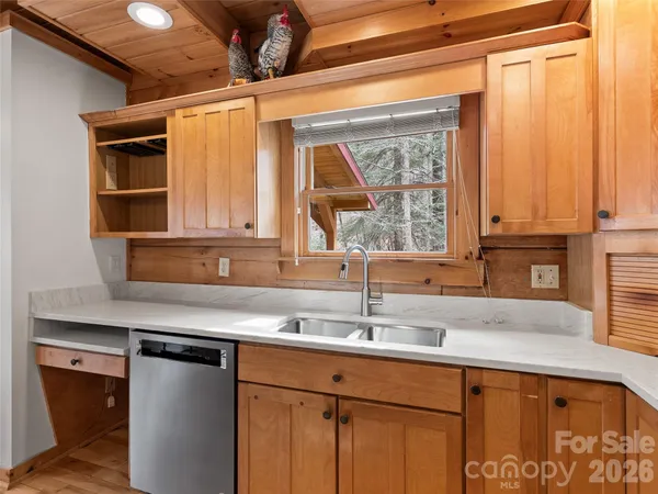 a kitchen with stainless steel appliances a sink and a window