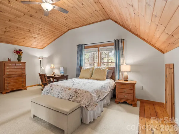 a spacious bedroom with a bed and a cabinets