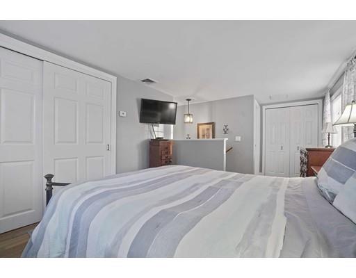 40 Sunflower Road Holbrook, MA 02343 - Photo 17 of 26 a bedroom with a bed and a flat tv screen on dresser