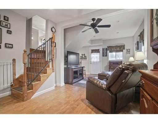 40 Sunflower Road Holbrook, MA 02343 - Photo 18 of 26 a living room with furniture a flat screen tv and a window