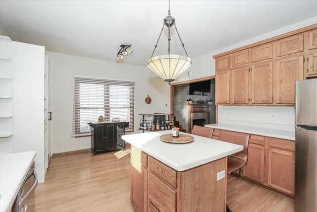 a kitchen with a center island appliances and cabinets