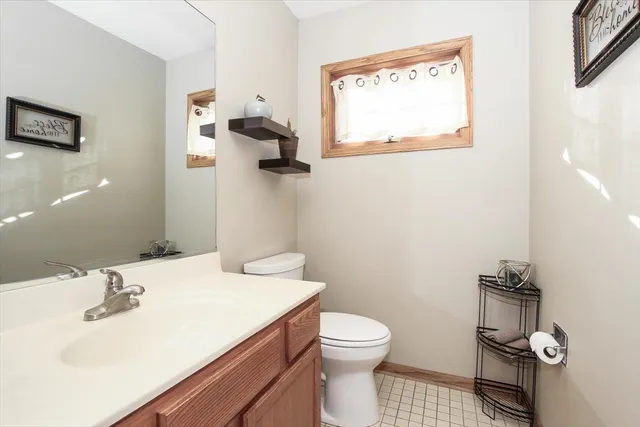 a bathroom with a sink toilet and mirror