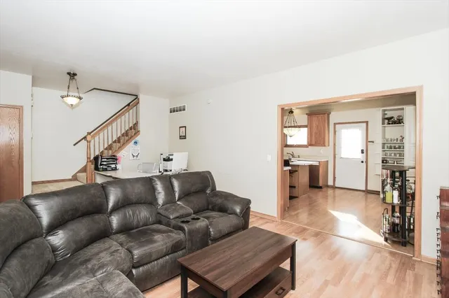 a living room with furniture and wooden floor