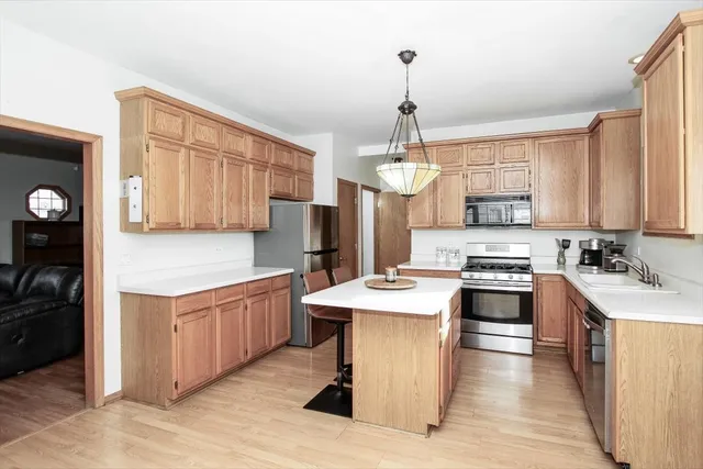 a kitchen with stainless steel appliances a sink stove and refrigerator