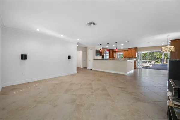 a view of a kitchen with furniture and wooden floor