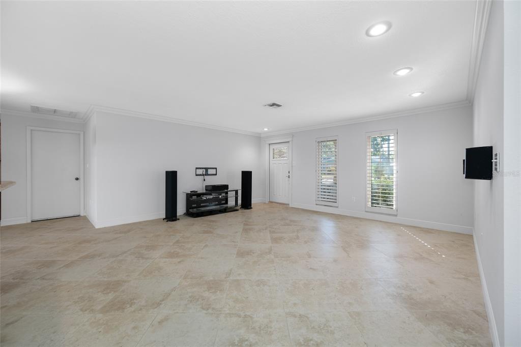 5473 97th Way North St. Petersburg, FL 33708 - Photo 13 of 62 a view of an empty room with a window and a kitchen