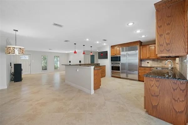 an open kitchen with cabinets and stainless steel appliances
