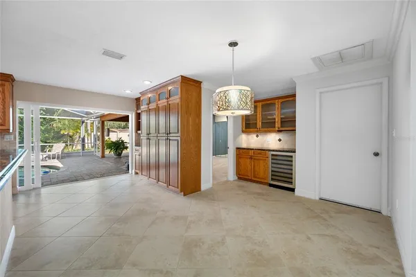 a view of a kitchen with refrigerator and cabinets