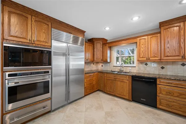 a kitchen with granite countertop stainless steel appliances and cabinets
