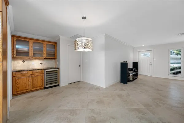 a view of an empty room with a kitchen