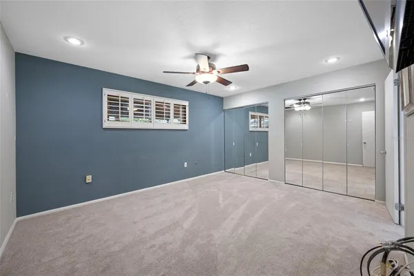 a view of an empty room with a ceiling fan