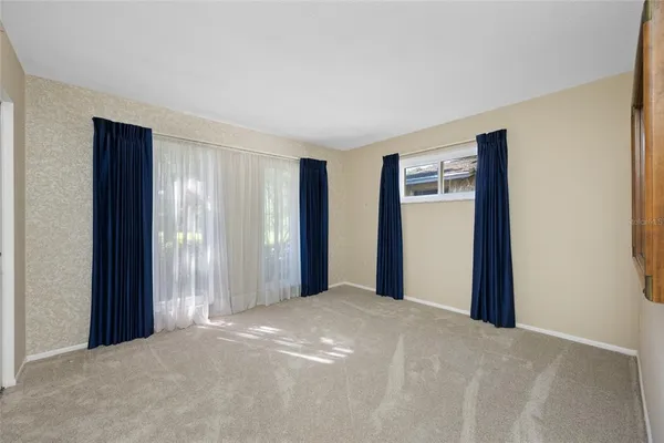 a view of a big room with closet and windows